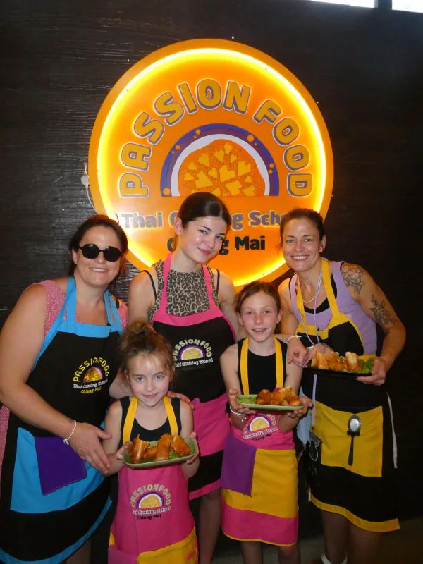 A family with young children in Passionfood aprons